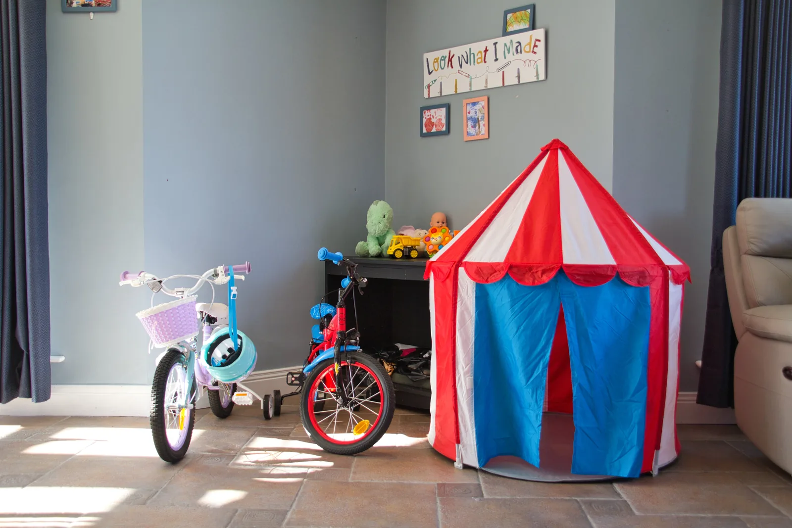 A playroom with a play tent and a bicycle